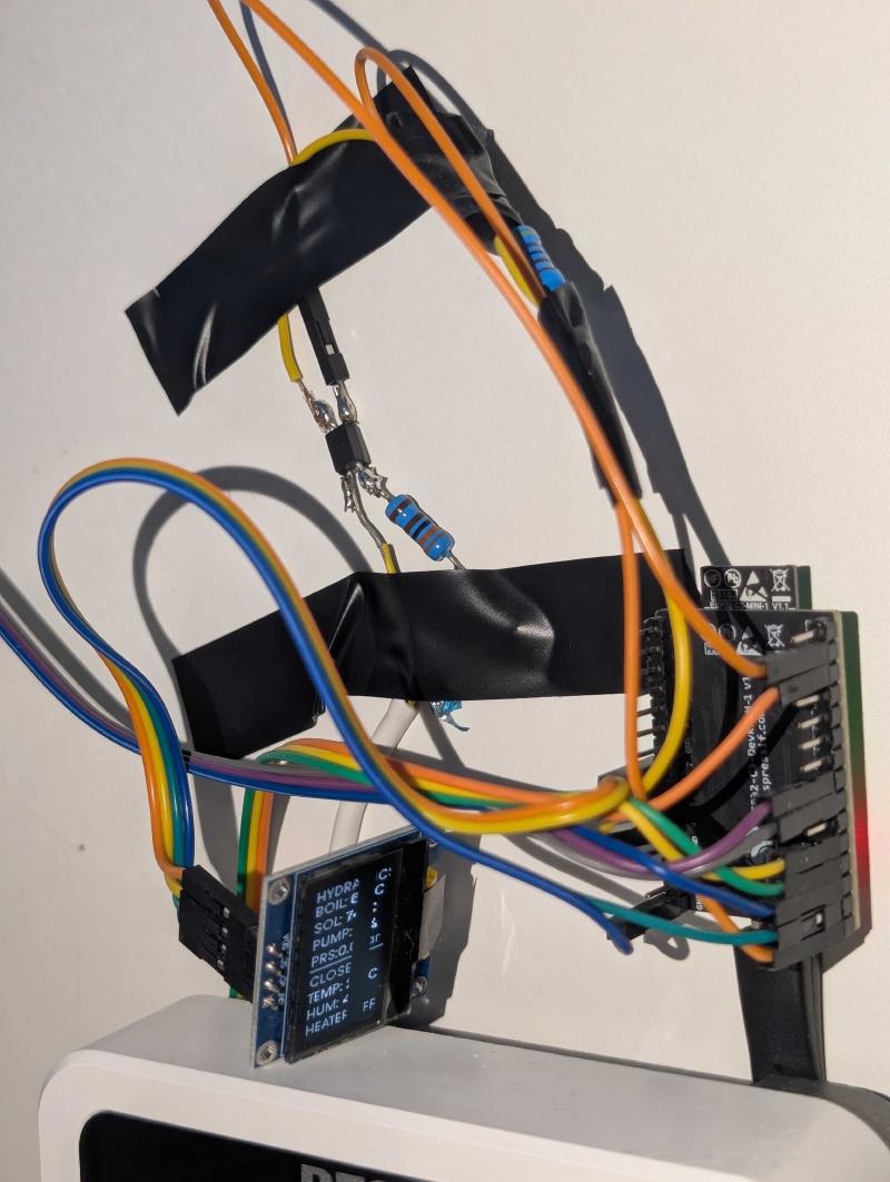 The optocoupler circuit with resistors connecting VBus to the ESP32, plus the OLED display showing live readings