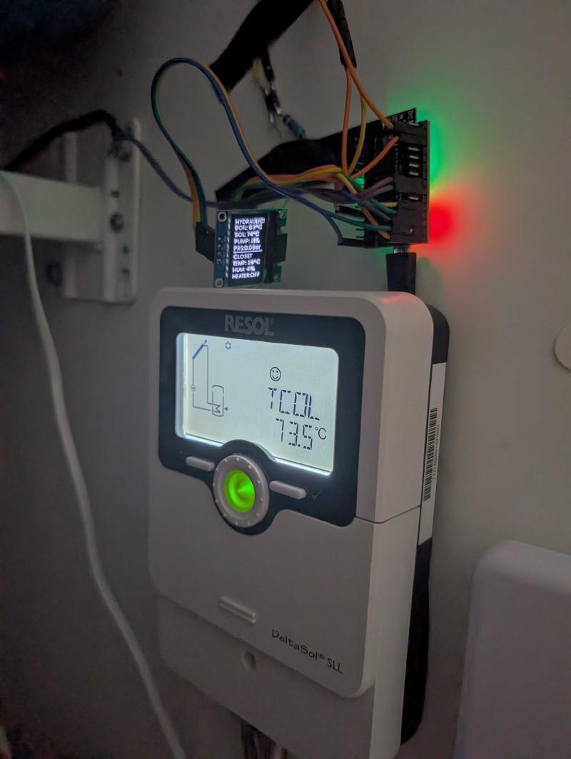 The complete setup — ESP32 with OLED and status LED mounted above the Resol DeltaSol SLL controller