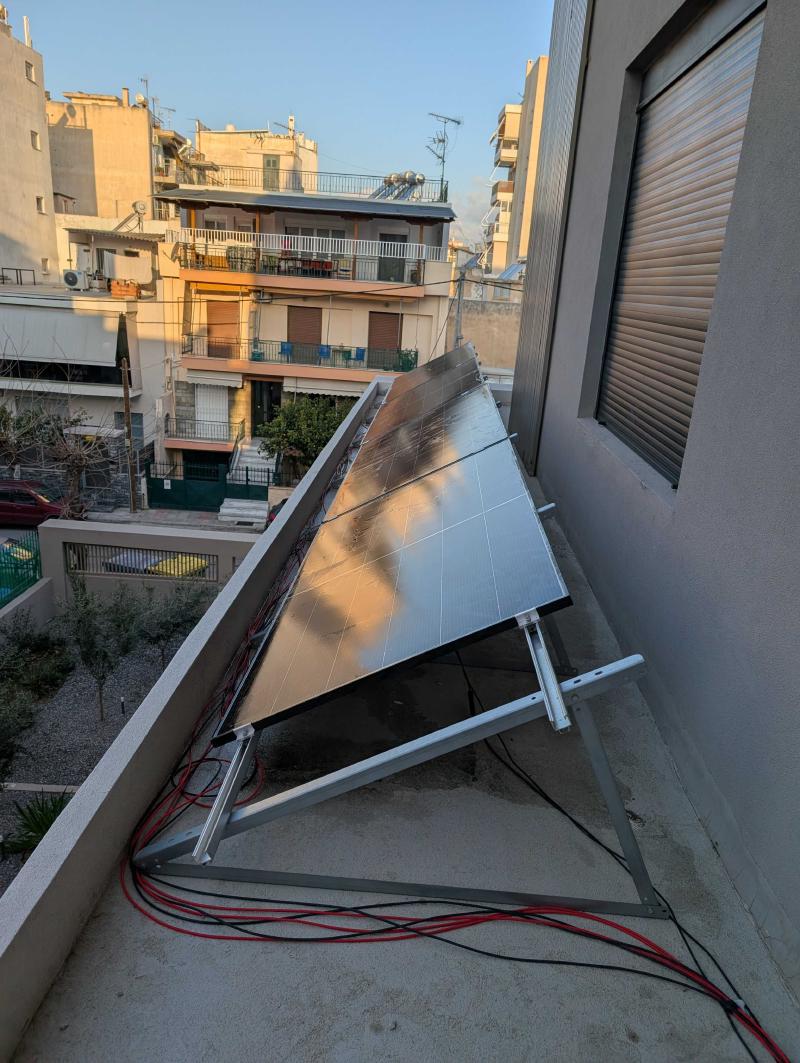 The bifacial solar panels mounted on the balcony — urban solar at its finest